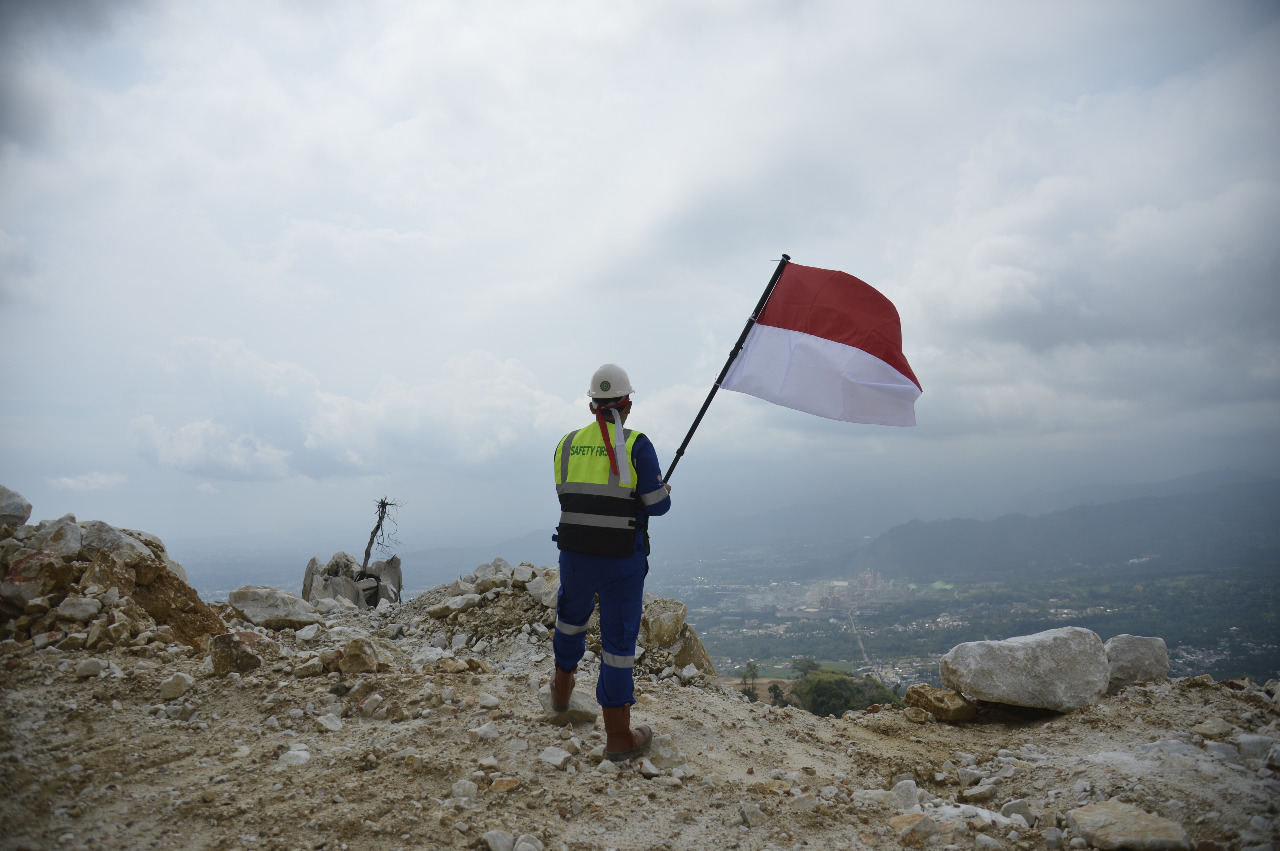 Kibarkan bendera: Seorang karyawan Semen Padang mengibarkan bendera Merah Putih dari Tambang Semen Padang di Karang Putih