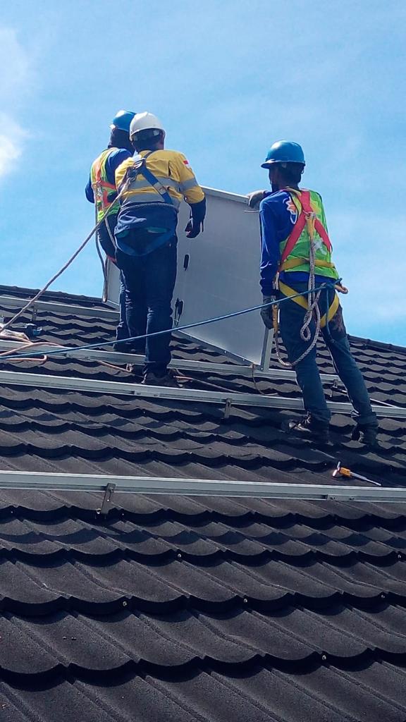 Sejumlah pekerja memasang panel surya Solar Cell di atas atap Pabrik Kantong PT Semen Padang di Bukit Putus, Kelurahan Pampangan, Kota Padang.