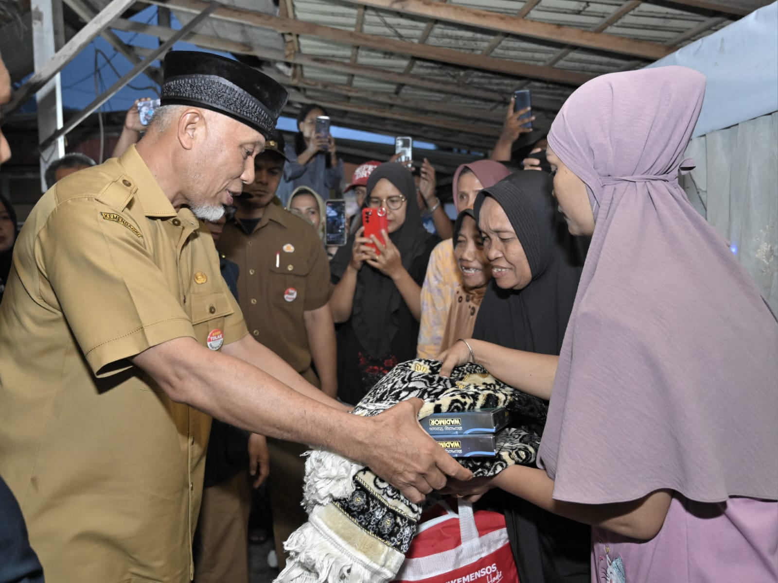 Gubernur Sumbar, Mahyeldi, menyalurkan bantuan logistik bagi warga korban bencana kebakaran di Kelurahan Pampangan Nan XX, Kecamatan Lubuk Begalung, Padang, Selasa (9/1/2024) malam. Foto Adpsb. 