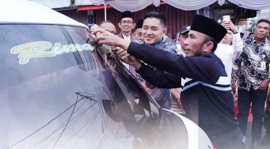 Wawako Allex saat memasang stiker angkutan gratis pelajar diterminal mikrolet.