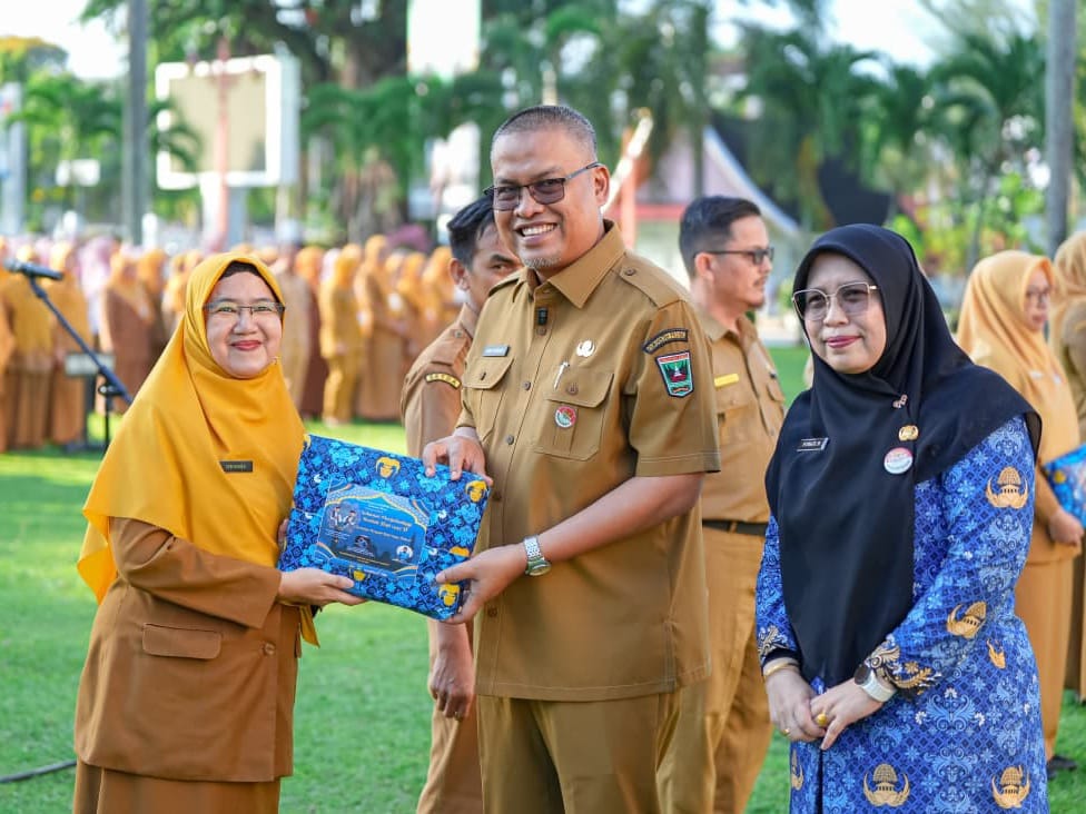 Sekretaris Daerah Provinsi Sumatera Barat, Arry Yuswandi, menyerahkan bingkisan kepada ASN yang akan berangkat haji tahun ini, di halaman Kantor gubernur, Senin (20/4/2026). Foto Adpsb. 