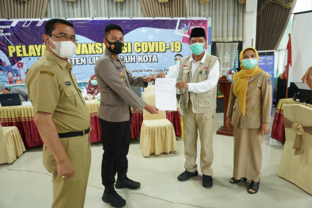 Buoati Limapuluh Kota Irfendi Arbi serahkan surat keterangan kepada Kapolres Limapuluh Kota yang telah dua kali divaksinasi.