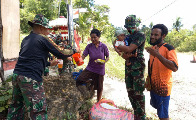Prajurit TNI Satuan Petugas (Satgas) Pengaman Batas (Pamtas) Yonif 131/Braja Sakti berbaur dengan masyarakat Papua.