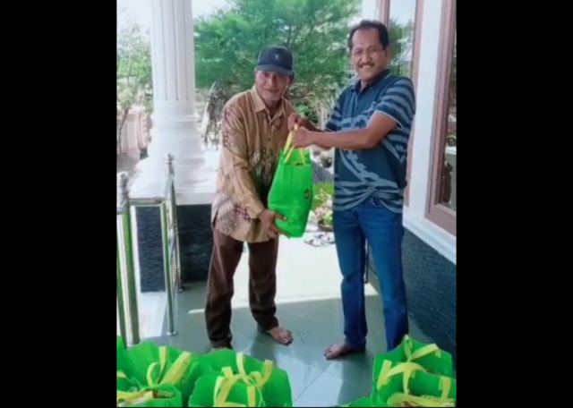 Direktur PT Guguk Tinggi Defrizal Chon Menyerahkan Paket Sembako ke Warga Sekitar Perusahaan, Kamis (22/4)