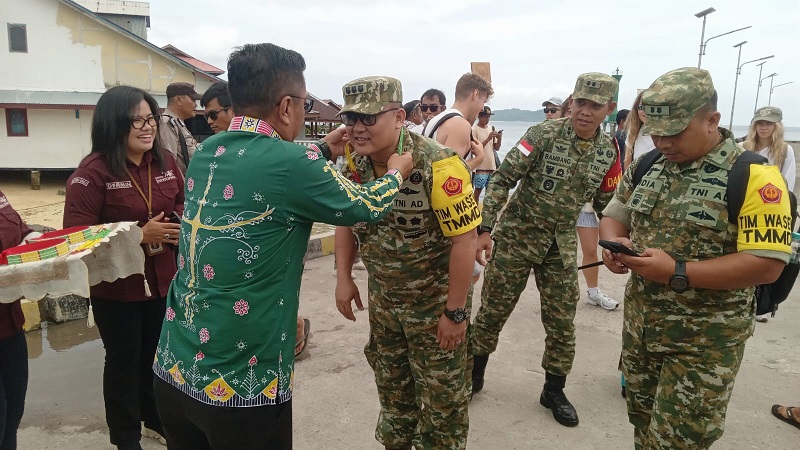 Sekda Martinus Dahlan mengalungkan Plakat Sikerei Kepada Ketua TimWasev Kolonel Fransisco di Dermaga Pelabuhan Tuapeijat pada sesi penyambutan di dampingi pimpinan Forkopimda
